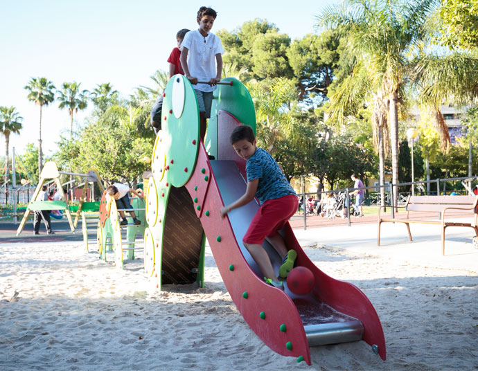 children playing with a slide which has the form of an animal