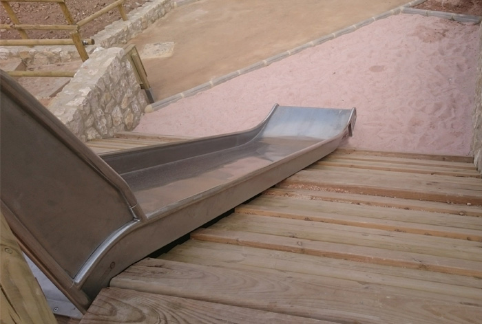 metal slide on embankment of wooden boards